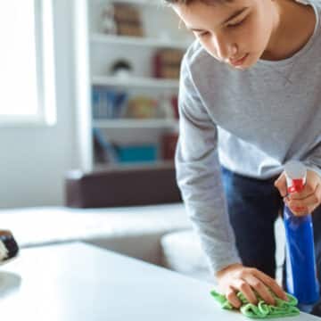 How to Reduce Dust in Your Bala Cynwyd, Home. A boy dusting off a table.