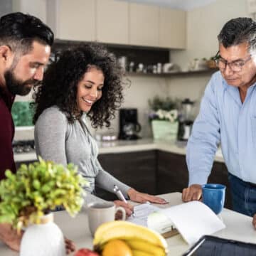 Think HVAC During Your Home Remodeling. Mid adult couple filling out a document in the kitchen at home